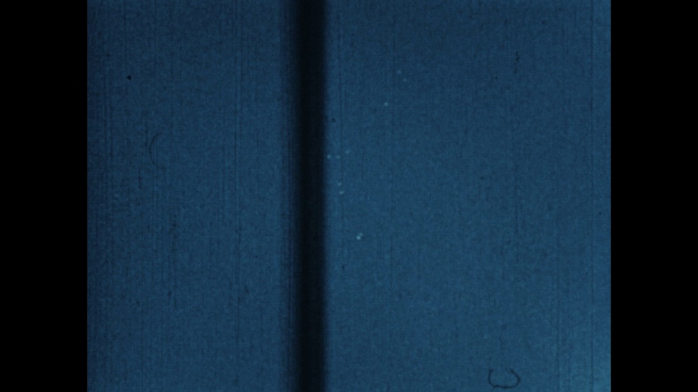 A frame of the 1952 Tremonton film as published by the Department of War: two strips of blue Kodachrome sky with faint pale specks.