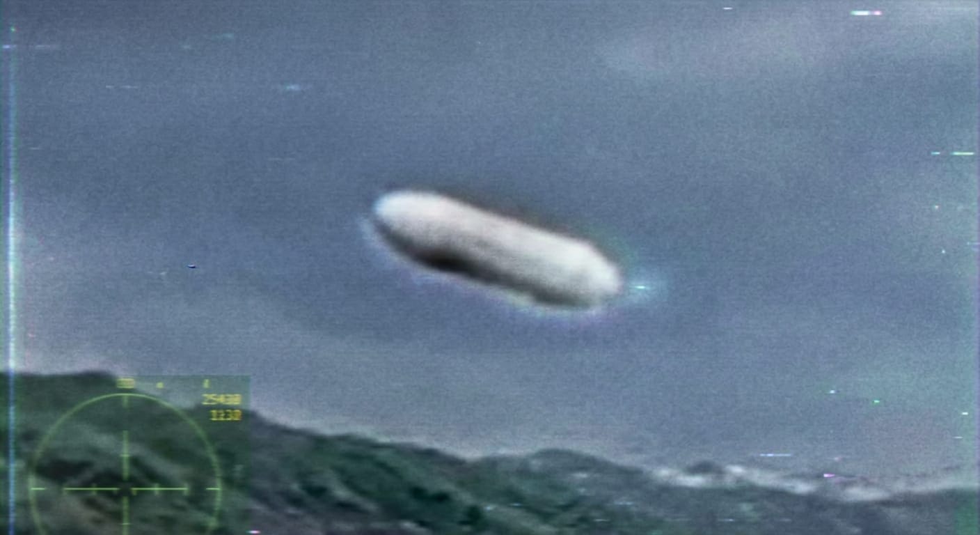 Illustration of a cigar-shaped or fat-spherical UAP captured on military sensor — matching the description in Luna's Item #4